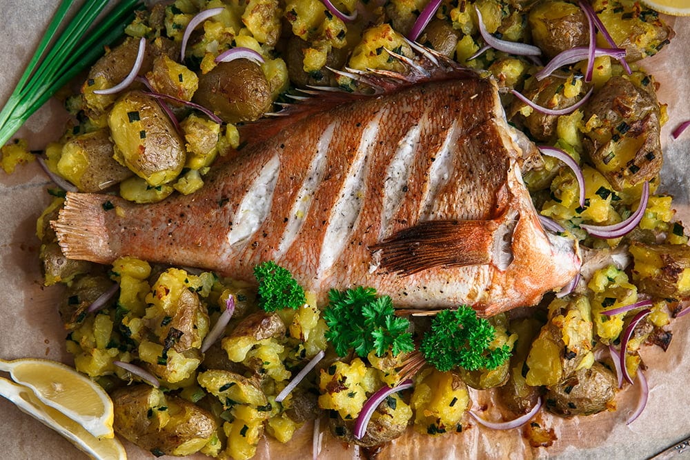 Close view of red grouper baked with potatoes, top view