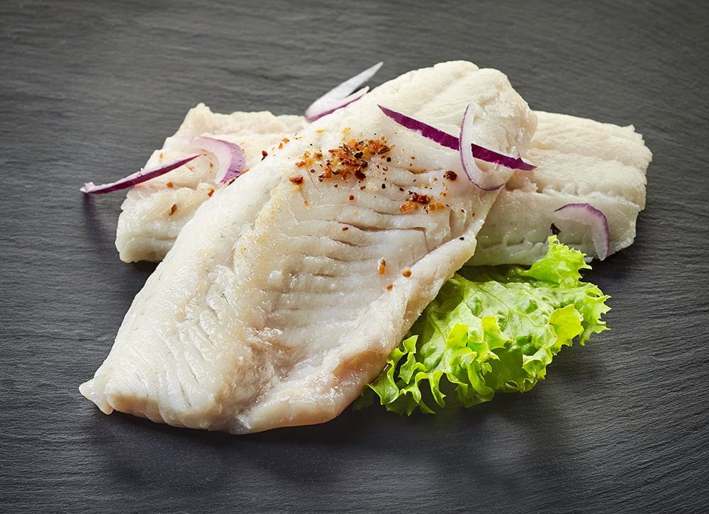 roasted perch fish fillets on black background