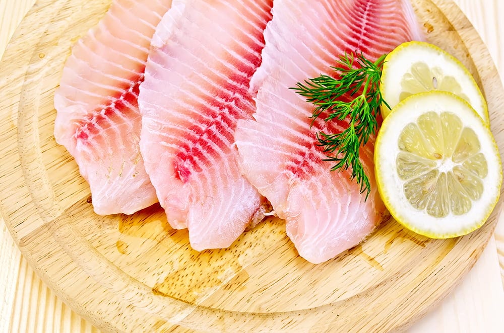 Fillets tilapia on a round board